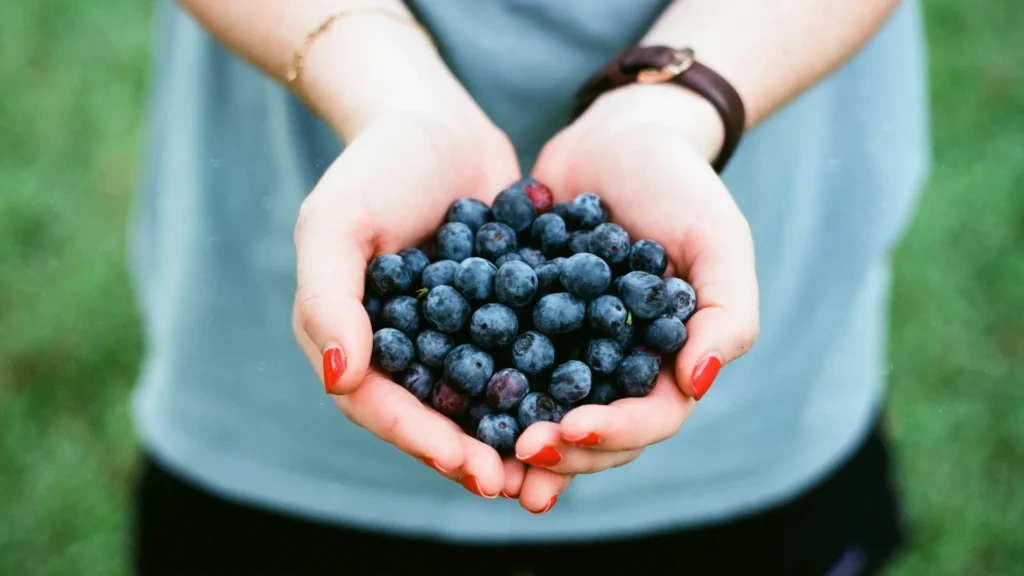 woman with hand full of berries